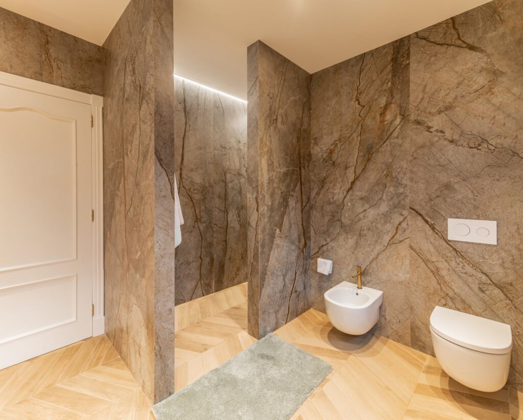 Baño principal con paredes de piedra veteada