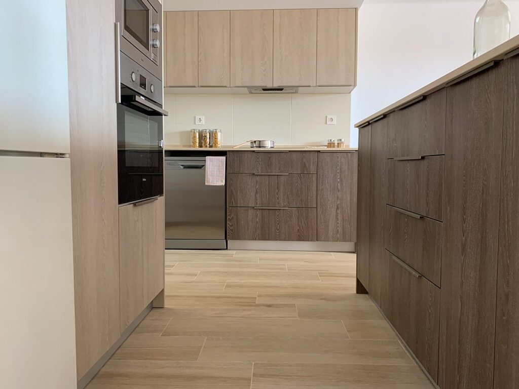 Cocina en roble y blanco reformada por Fustecma