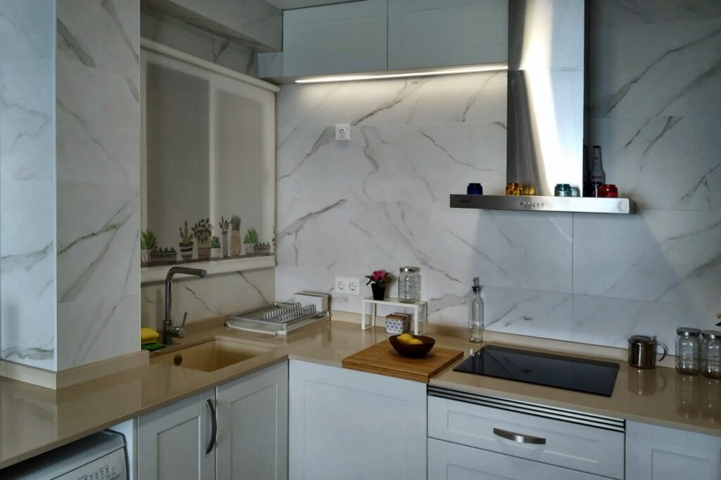 Cocina en U con encimera Compac en tono arena